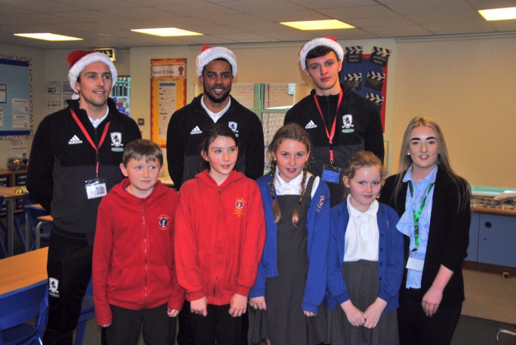 Stewart Downing, Cyrus Christie and Dael Fry pose for a photo with pupils from Rose Wood Academy